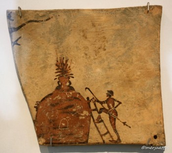 Fig.5: Clay panel from Penteskouphia, Corinth (Greece) depicting a potter trying to close                     the kiln’s opening to create a reductive environment                              (https://www.flickr.com/photos/130870_040871/33465480171/in/photostream/).